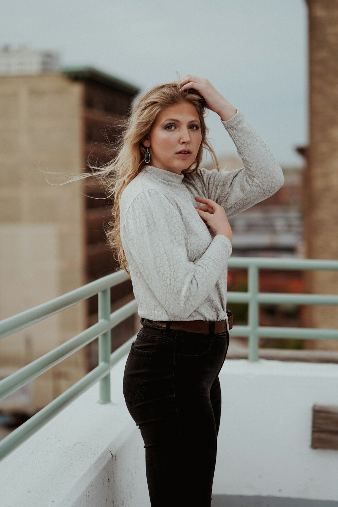 Portrait of a young woman with blonde hair in a smart casual outfit